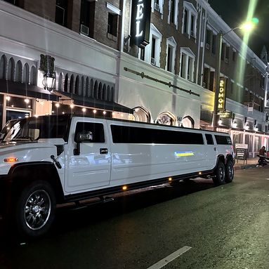 Six-wheel dual-axle Hummer limousine at night