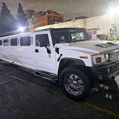 Hummer H2 stretch limousine lit up at night